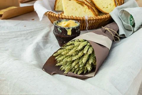 Composition rustic bouquet wheat ears of light green honey pot fresh bread Stock Photos