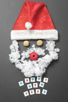 Composition with Santa's hat, walnuts, a ball of thread and fiberfill. Funny Stock Photos