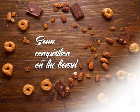 Composition of scattered nuts, chocolate and tartallin on a brown background  Stock Photos