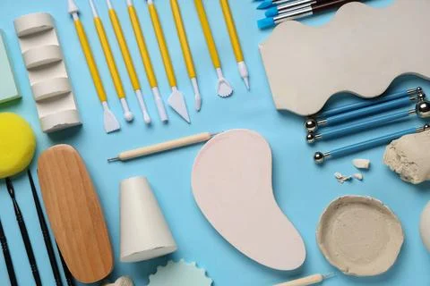 Composition with set of sculptor tools, clay and plaster figures on blue back Stock Photos