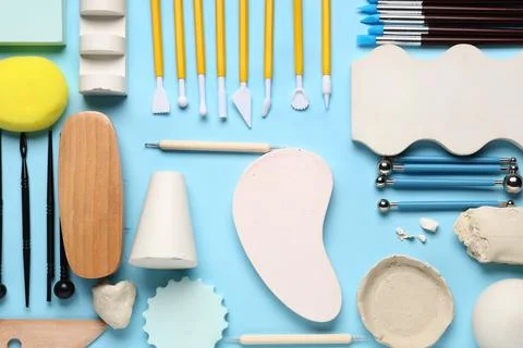 Composition with set of sculptor tools, clay and plaster figures on blue back Stock Photos
