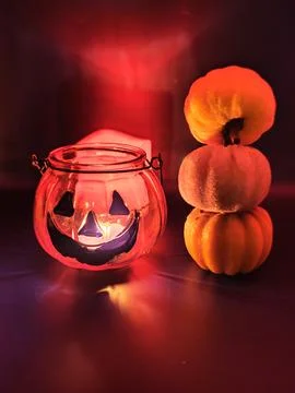 A composition of several pumpkins against a red, ominous background. Macro photo Foto stock