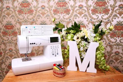 Composition from a sewing machine. Mannequin, flowers on a retro table and th Stock Photos