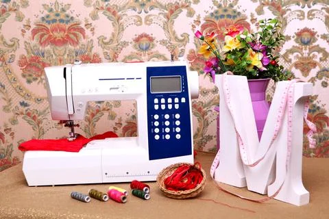 Composition from a sewing machine. Mannequin, flowers on a retro table and th Stock Photos