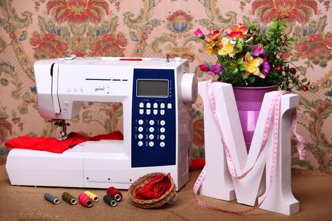 Composition from a sewing machine. Mannequin, flowers on a retro table and th Stock Photos