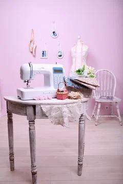 Composition from a sewing machine. Mannequin, flowers on a retro table and th Stock Photos