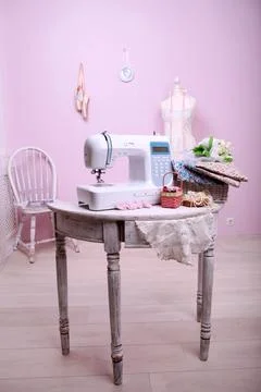 Composition from a sewing machine. Mannequin, flowers on a retro table and th Stock Photos