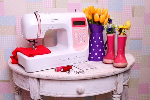 Composition from a sewing machine. Mannequin, flowers on a retro table and th Stock Photos