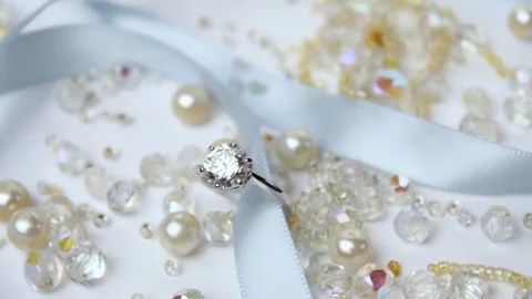 Composition of a  shiny gold wedding ring with diamonds on a white background Stock Footage 123285322