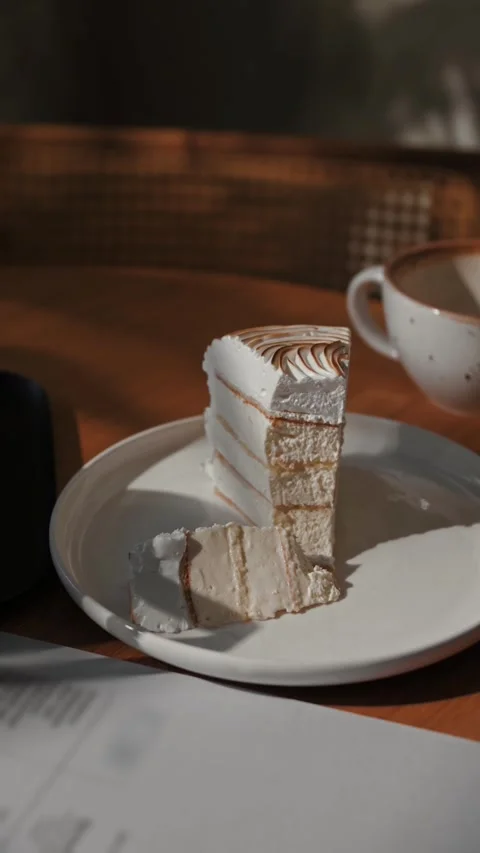 Composition of a slice of fresh sweet cake and a cup of coffee after a meal Stock Footage 310500468
