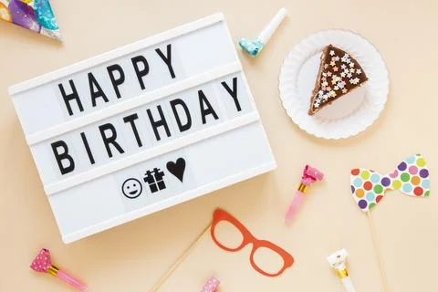 Composition with sliced cake birthday lettering Stock Photos
