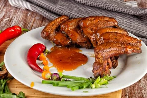 Composition with smoked chicken wings on the table 库存照片