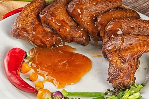 Composition with smoked chicken wings on the table Stock Photos