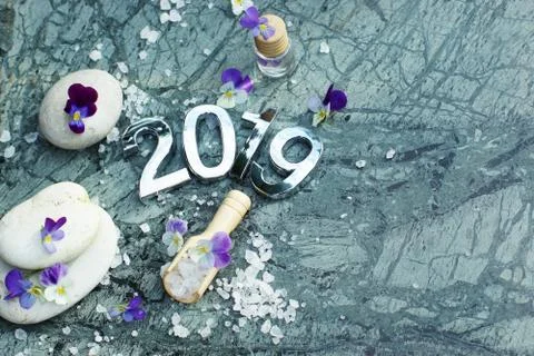 Composition Spa set with figures 2019 on marble with purple flowers, stones a Stock Photos
