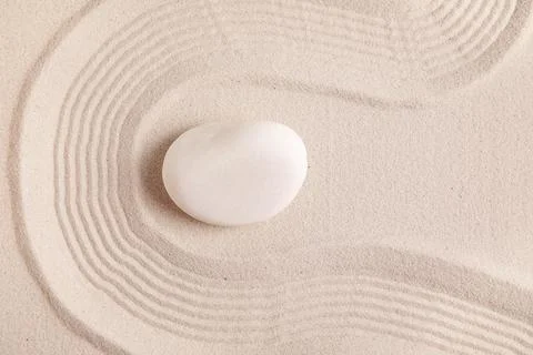 Composition with spa stone and lines on sand as background, closeup. Zen conc Stock Photos