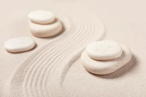 Composition with spa stones and lines on light sand as background, closeup. Z Stock Photos