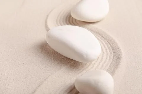 Composition with spa stones and lines on sand as background, closeup. Zen con Stock Photos