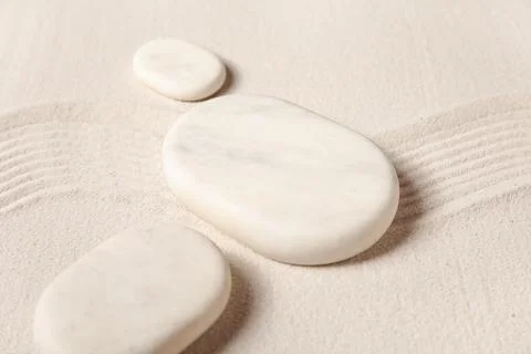Composition with spa stones and lines on light sand as background, closeup. Z Stock Photos