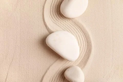 Composition with spa stones and lines on light sand as background, closeup. Z Stock Photos