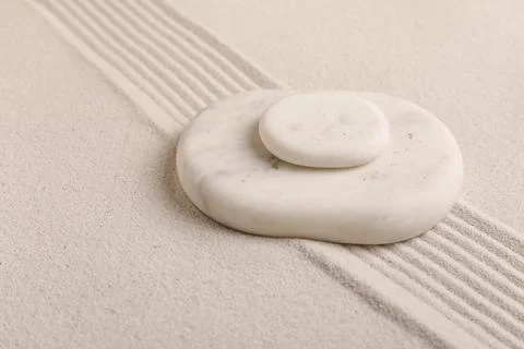 Composition with spa stones and lines on sand as background, closeup. Zen con Stock Photos