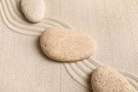 Composition with spa stones and lines on sand as background, closeup. Zen con Stock Photos