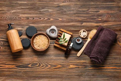Composition with spa stones, candles, spoon and bowl of sea salt on wooden ba Stock Photos