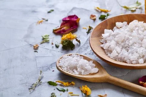Composition of spa treatment on white background. Sea salt and flowers Stock Photos