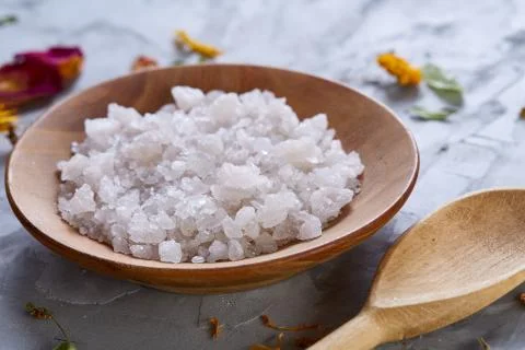 Composition of spa treatment on white background. Sea salt and flowers Stock Photos