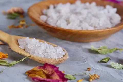 Composition of spa treatment on white background. Sea salt and flowers Stock Photos