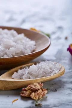 Composition of spa treatment on white background. Sea salt and flowers Stock Photos