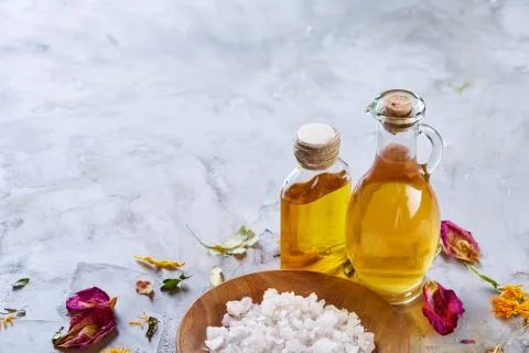 Composition of spa treatment on white background. Sea salt and flowers Stock Photos