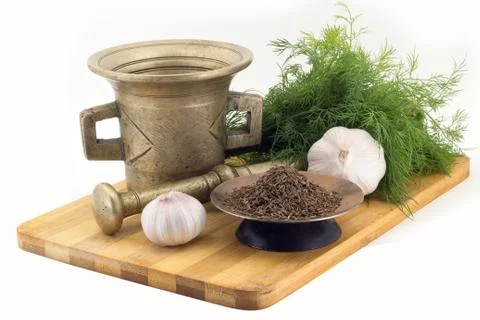 Composition of spices, cumin, dill, garlic, vintage spice grinder isolated .. Stock Photos