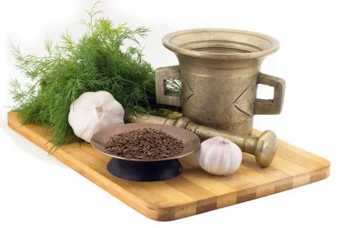 Composition of spices, Cumin, dill, garlic, vintage spice grinder isolated .. Stock Photos