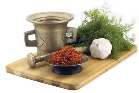Composition of spices, raw Imerin saffron, dill, garlic, vintage spice grin.. Stock Photos