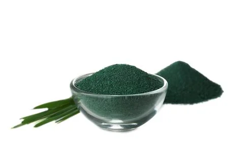 Composition with spirulina algae powder and grass isolated on white Stock Photos