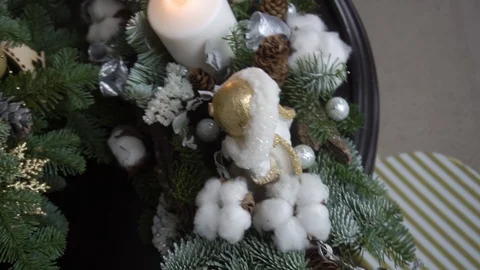 Composition of spruce branches with the addition of snowflakes, toys and candles Видео 122287926