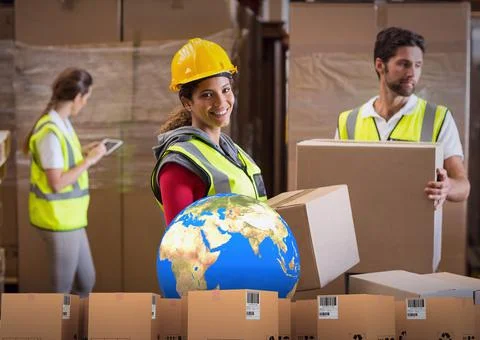Composition of stack of cardboard boxes with globe with workers carrying boxes Stock Photos
