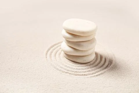 Composition with stack of spa stones and lines on light sand as background, c Stock Photos