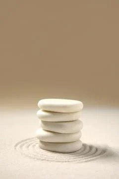 Composition with stack of spa stones and lines on light sand as background, c Stock Photos