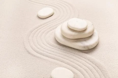 Composition with stack of spa stones and lines on light sand as background, c Stock Photos