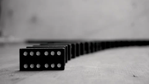 Composition of standing black domino bricks with white dots. Stockfoto's