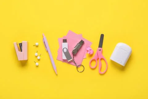 Composition with stationery and modern flash drives on yellow background Foto stock