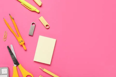 Composition with stationery and modern flash drives on pink background Foto stock