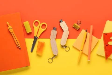 Composition with stationery and modern flash drive on color background Stock Photos