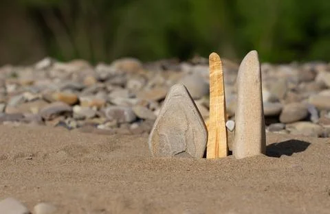 Composition of stones on the beach of the river in the sand. background. Stock Photos