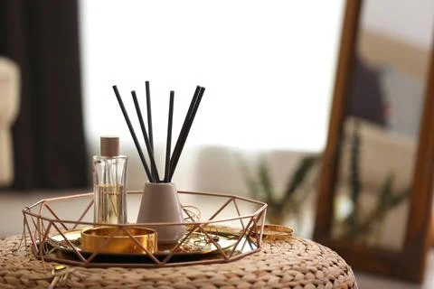 Composition with stylish accessories and interior elements on wicker pouf ind Foto stock