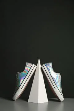 Composition with stylish shoes on table against dark background. Space for te 스톡 사진