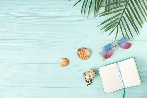 Composition sunglasses with notebook palm leaves. High quality photo Stock Photos