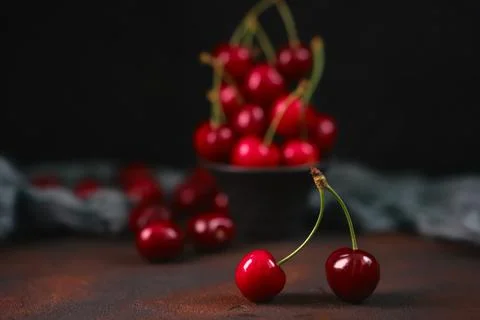 Composition of sweet cherries on a dark background with water drops top view Stock Photos