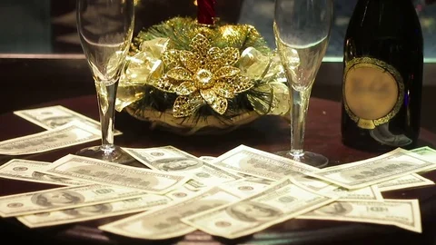 The composition: on the table a bottle of champagne, two glasses, and dollars. Stock Footage 70841808